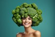 girl with a broccoli hairstyle on her head on an emerald background. place for text