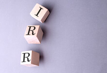 Word IRR On Wooden Block On The Grey Background