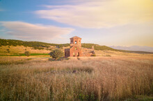 Red Church Ruins In Nigde Province, Sunset Colors And Clouds In The Sky And Sun Light