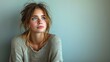 © ME_Photography - Lone woman sitting on stool against grey background, stock photo, light blue and gray, raw emotions, stylish