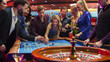 © Kitreel - Footage of a Spinning Roulette Wheel. Female and Male Guests Placing Risky Bets while Playing Roulette. Crowd Celebrating a Positive Outcome and Cheering the Winners