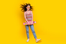 Full Size Photo Of Overjoyed Woman Dressed Knitwear Top Hold Skateboard Look At Promo Empty Space Isolated On Yellow Color Background