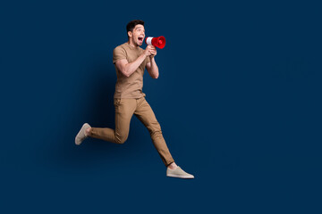 Canvas Print - Full size photo of crazy man wear beige outfit running look at empty space sale screm in megaphone isolated on dark blue color background