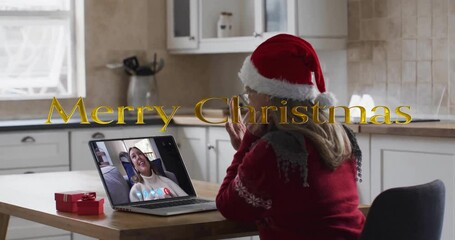 Poster - Animation of merry christmas text over caucasian woman on laptop screen