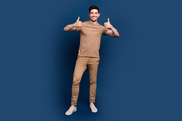 Sticker - Full size photo of satisfied optimistic man dressed beige t-shirt two arms showing thumbs up isolated on dark blue color background