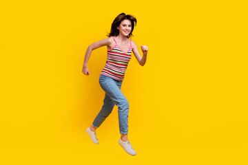 Poster - Full size photo of energetic gorgeous woman dressed knit top jeans run shopping to empty space isolated on yellow color background