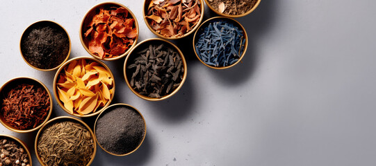 Various kind of leaf tea on a gray background, top view.	
