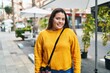 © Krakenimages.com - Young beautiful plus size woman smiling confident standing at coffee shop terrace