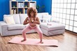 © Krakenimages.com - African american woman smiling confident training yoga at home