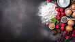 Ingredients for cooking baking, baking background. Flour, sugar, eggs, spices and utensil on black background. Top view with copy space.