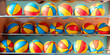 Multicolored basketball balls located in row indoor of sport school gym or medical rehabilitation centre