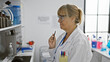 © Krakenimages.com - Blonde middle age woman scientist, doubting and deep in thought at computer in laboratory work