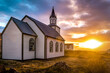 Typical rural Icelandic Church at sea coastline on sunset
