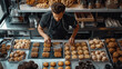 Male chef in black dress from the top in the white premium bakery with freshly baked cookies