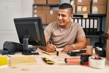 Canvas Print - Young latin man ecommerce business worker writing on package at office