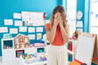 © Krakenimages.com - Young caucasian woman working as teacher at kindergarten with sad expression covering face with hands while crying. depression concept.