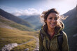 Young happy, smiling woman hiking in the mountains, trekking in nature in a sunny day, excited exlorer in the wlld on a trail. Travel and active lifestyle concept.