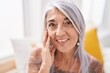 © Krakenimages.com - Middle age grey-haired woman smiling confident sitting on bed at bedroom