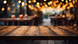 Empty wooden table in front of abstract blurred background of cafe or restaurant.