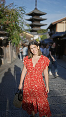 Sticker - Beautiful hispanic woman smiling joyfully, confidently posing, standing on the old traditional streets of gion, kyoto, her sunny, carefree nature shining through for a fun-filled japan adventure.