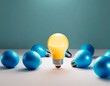 Energy saving lightbulb and blue plastic balls on a white table