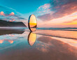 Mirror reflection on the beach at sunrise. Beautiful nature background.
