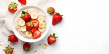 Bowl Of Oatmeal Porridge With Strawberry And Banana On White Table Top View. Healthy And Diet Breakfast.