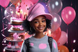 © yanapopovaiv - dark-skinned girl smiling in a cap celebrates her birthday with cupcakes and balloons