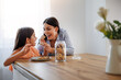 © ivanko80 - Mother and daughter in new kitchen, eating cookies