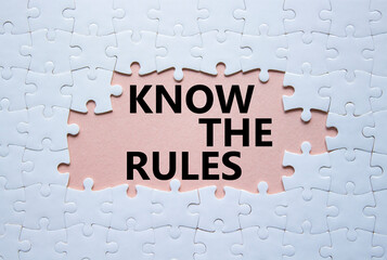 Sticker - Know the rules symbol. Concept words Know the rules on white puzzle. Beautiful pink background. Business and Know the rules concept. Copy space.