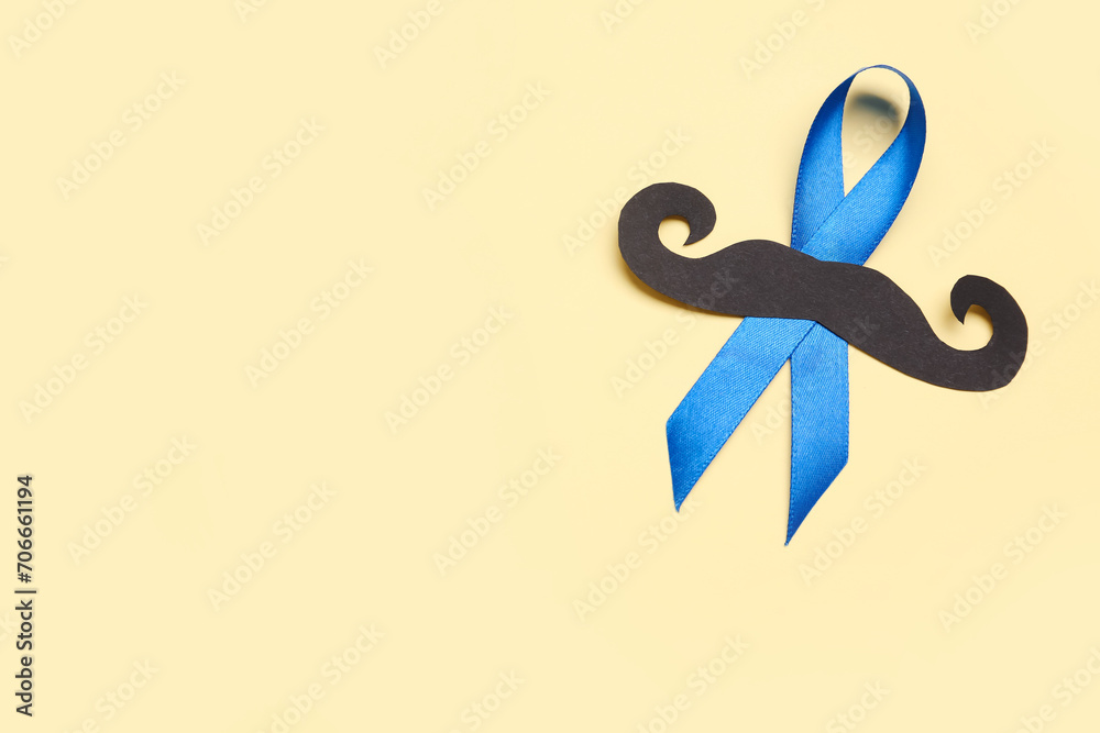 Blue awareness ribbon with black paper mustache on color background