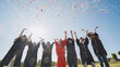 © Довидович Михаил - Happy college graduates throw colorful confetti against the rays of sunshine.