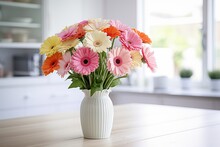 Bouquet Of Gerbera Flower In Vase On Kitchen Table