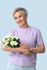 Poster - Mature woman with beautiful roses on light background