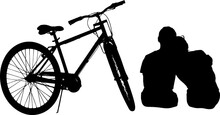 Silhouette Of A Couple Next To A Bike