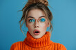 © Gonzalo - Photo of shocked impressed woman dressed orange sweater getting dislikes modern gadget isolated blue color background