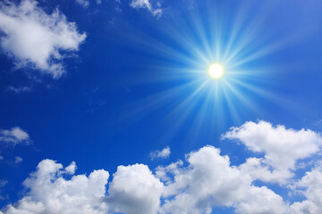 Wall Mural - Blue sky background with sunlight and white clouds. Nature summer background.
