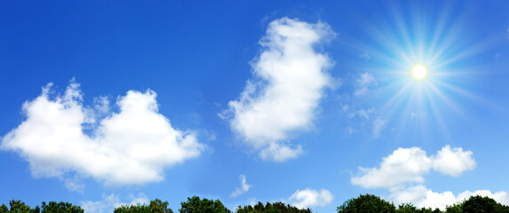 Wall Mural - Blue sky background with sunlight and white clouds. Nature summer background.