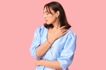 Poster - Fashionable young woman with stylish jewellery on pink background