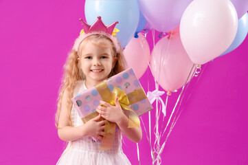 Wall Mural - Cute little girl with Birthday gift and balloons on purple background