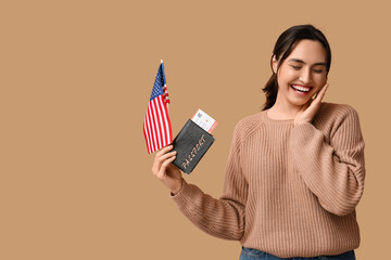 Wall Mural - Pretty young woman with USA flag and passport on beige background. Immigration concept