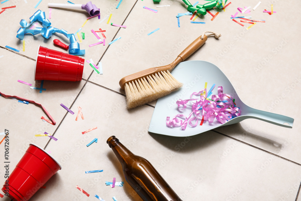 Dustpan with brush and mess on tile floor after party, closeup