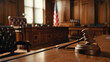 A wooden gavel rests on its sounding block at the forefront of an American courtroom, with the blurred backdrop of stately benches and the iconic flag, representing the solemnity of the law.