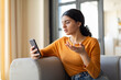 © Prostock-studio - Frustrated young indian woman looking at her smartphone with gesture of disbelief