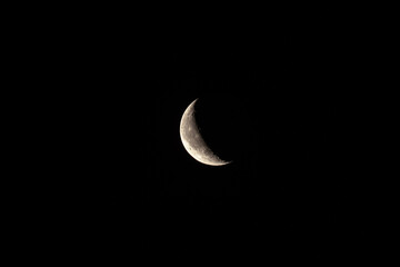 moon on black background. waning moon in sky close-up. earth satellite.
