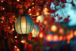 Beautiful blue glowing Chinese lanterns hanging on sakura tree on a blurred bokeh background