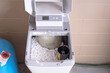 Water softener with lid open. Water softener with salt pellets in the tank