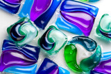 Fototapeta Las - Washing capsules, colorful laundry pods. Colorful Soluble capsules with laundry gel detergent and dishwasher soap. Pile of various washing pod capsules. Detergent tablets. Top View, Flat Lay. 