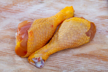 Wall Mural - Image of raw chicken hams before cooking on the table with greens and garlic