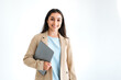© Kateryna - Female successful entrepreneur. Confident indian or arabian business woman, office worker in elegant suit, holding laptop, standing on isolated white background, looks at camera, smiling